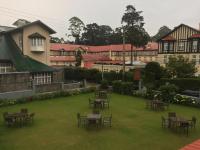 a group of tables and chairs on a lawn at Grand Bungalow Nuwara Eliya by Seven Angels in Nuwara Eliya