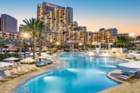 a swimming pool with a resort in the background at Orlando World Center Marriott in Orlando