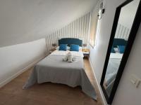 A bed or beds in a room at Apartamentos Pedregalejo Beach Playa