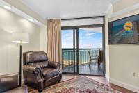 sala de estar con silla y balcón en Sand Dunes Resort Unit 1406 - Ocean View, en Myrtle Beach