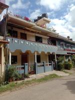 a building with flowers on the top of it at Nakshatra Homestay in Madikeri