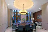 a dining room with a table and chairs at Sanya Han's Grace Hotel in Sanya