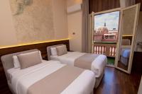 two beds in a room with a view of a building at Egyptian Night Hostel in Cairo