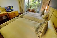 a hotel room with two beds and a television at Jun Yue Hanging Garden Resort in Ren&#39;ai