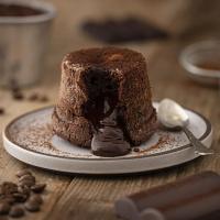 a chocolate cake on a plate with a spoon at Hostal Casa De Arcos in Puebla
