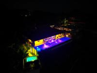 Una casa iluminada por la noche con luces moradas y azules. en Ciel y Miel, en Colón