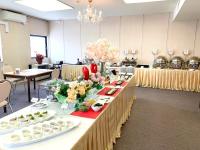 a large room with a long table with food on it at ホテルロイヤル北見 in Kitami