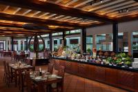 a restaurant with tables and chairs and a bar at Cinnamon Lodge Habarana in Sigiriya