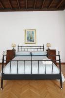 A bed or beds in a room at Palazzo 1500 Frescobaldi - Piano nobile x 5 - A Casa di Alfonso