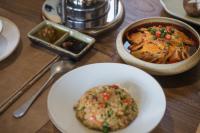 a table with plates of food and a bowl of food at Hegu Retreat Qingcheng in Jiezi Ancient Town
