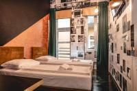 two beds in a room with posters on the wall at Timeout Heritage Hotel Zagreb in Zagreb