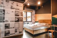 a bedroom with a bed and a wall with posters at Timeout Heritage Hotel Zagreb in Zagreb