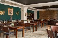 a dining room with wooden tables and chairs at Hoi An Odyssey Hotel & Spa in Hoi An