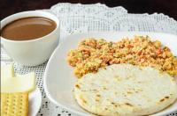 a plate of food and a cup of coffee at Hotel Valle del Café - Habitación 11 para Grupos de 4 Personas in Sevilla