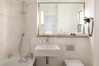 a white bathroom with a sink and a mirror at Best Western Hotel Le Bordeaux Sud in Gradignan