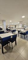a room with tables and benches in a building at Hotel Park Veredas in Rio Quente