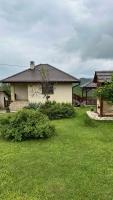 a house with a yard with green grass at Rudnicka vila in Arandjelovac