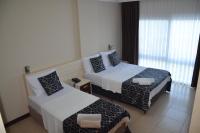 Postel nebo postele na pokoji v ubytování Denizkumu Hotel