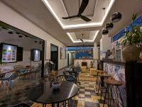 a restaurant with tables and chairs and a fireplace at Baahu Villa in Siem Reap