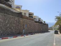 eine Steinmauer an der Seite einer Straße in der Unterkunft shohamseaview in Eilat