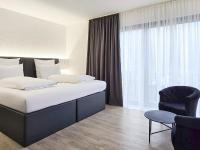 Ein Bett oder Betten in einem Zimmer der Unterkunft DORMERO Moselhotel Koblenz-Alken