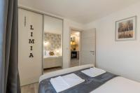 Łóżko lub łóżka w pokoju w obiekcie Apartments LIMIA