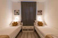 Łóżko lub łóżka w pokoju w obiekcie Apartments LIMIA