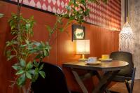 a table with two chairs and a lamp on it at Shanghai Zhuzhu Hotel - 24-hour free airport pick-up and drop-off at Pudong Airport in Shanghai