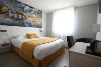 une chambre d&#39;hôtel avec un lit et un grand tableau sur le mur dans l&#39;établissement Logis hôtel - La Chambre D&#39;Amiens, à Amiens