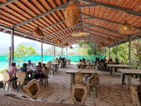 un grupo de personas sentadas en mesas en un restaurante en The Foresta Resort ,Mulshi, en Paud