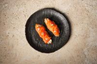 two pieces of food on a black plate at 1 Hotel Seattle in Seattle