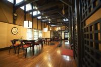a dining room with tables and chairs and a clock at Hotel Kazahaya in Hita