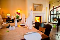 Hotel Wellness Goldenes Fass Meißen في ميسين: غرفة طعام مع طاولة ومدفأة