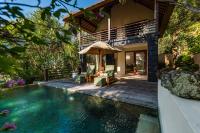 a villa with a swimming pool and a house at Qunci Villas Resort in Senggigi