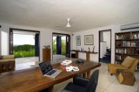 a living room with a table with a laptop on it at Qunci Villas Resort in Senggigi