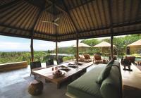 a living room with a couch and a table at Qunci Villas Resort in Senggigi
