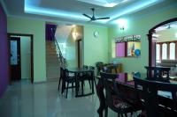 a dining room with a table and chairs at Sree Nandhavanam Homestay in Guruvāyūr