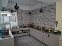 a kitchen with a stove and a stone wall at Hotel Flexi Residency Mumbai International Airport in Mumbai