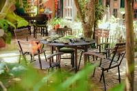 uma mesa de madeira e cadeiras com tigelas e pratos sobre ela em Yên homestay em Hoi An