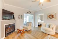 ein Wohnzimmer mit zwei Stühlen und einem Kamin in der Unterkunft Less Than 2 Mi to Beach Savannah Shores Resort Condo! in Myrtle Beach