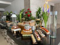 a buffet with many different types of cakes and pastries at Hotel Dorado Plaza Bocagrande - All Inclusive in Cartagena de Indias