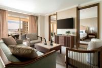 a living room with a couch and a bed and a television at The Ritz-Carlton, Sarasota in Sarasota