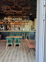 ein Restaurant mit Tischen und Stühlen und eine Bar in der Unterkunft Apartament Premium nad jeziorem, przy samej plaży miejskiej in Olsztyn