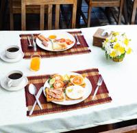 a table with two plates of eggs and toast at Chiang Ron in Chiang Mai