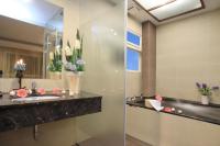 a bathroom with a sink and a mirror at Spring Fountain Hotel in Jiaoxi