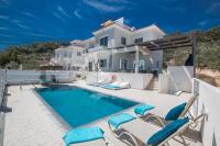 a villa with a swimming pool in front of a house at Romeo &amp; Juliet in Protaras