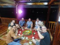 a group of people sitting around a table at Little Tay Homestay & Hostel in Làng Lap
