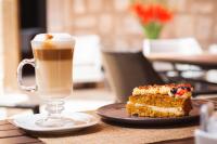 a piece of cake and a cup of coffee on a table at Hotel Boutique Casa Madero in Morelia
