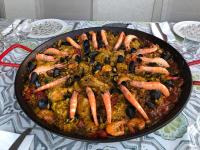 een pan met eten met garnalen en groenten op tafel bij Aux Belles Vacances - ADULTS ONLY in Caux-et-Sauzens