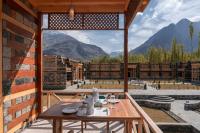 a table on a balcony with a view of mountains at Rivage Resort Skardu in Shigar